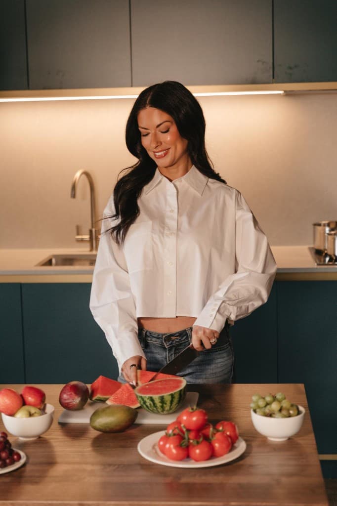 Woman preparing fresh fruit in the kitchen